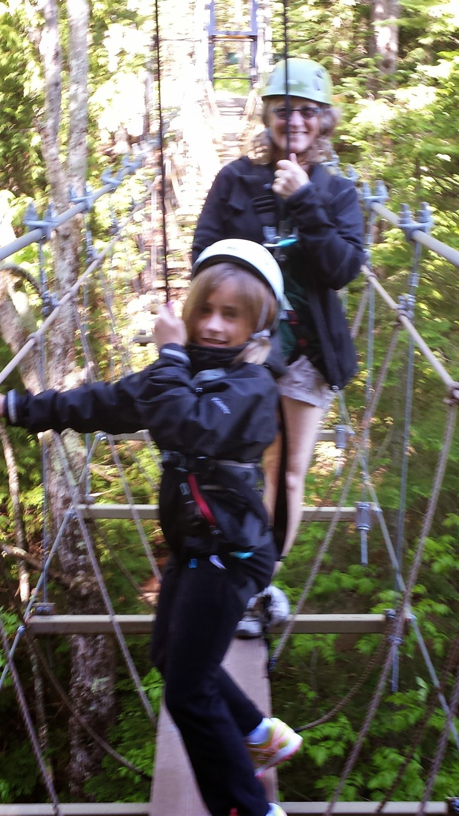 Thomas crossing the rope bridge high in the trees
