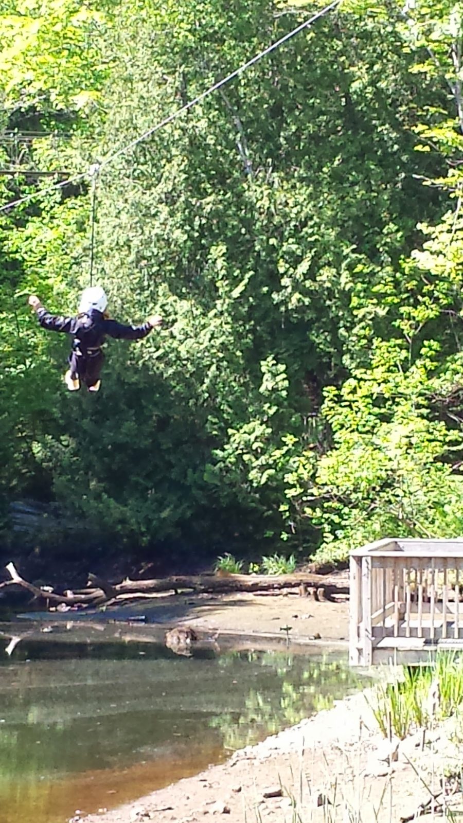 Flying across the zipline over water