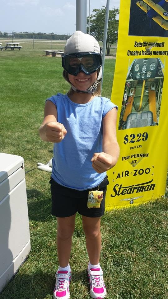 Lisa in her cap and goggles, ready for the biplane ride