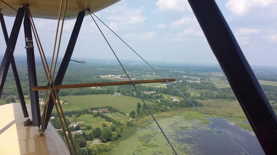 Farm fields and a lake from the biplane