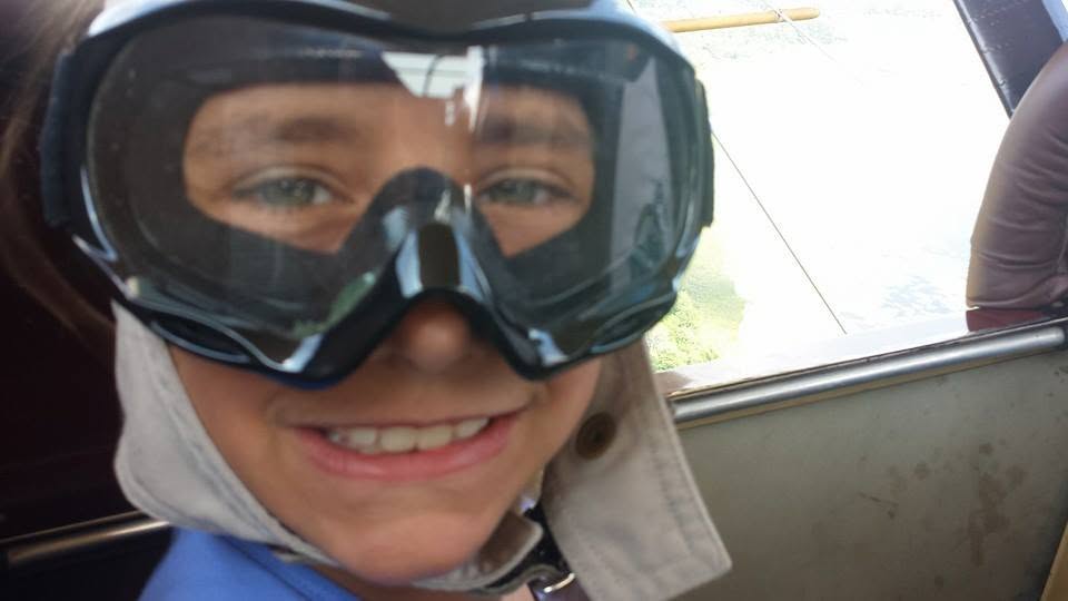 Lisa all smiles behind her goggles in flight