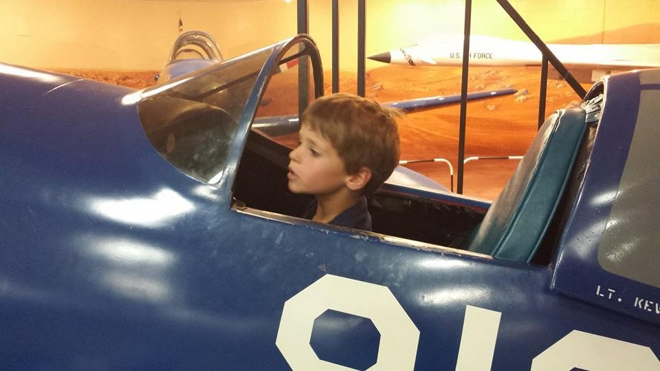 Thomas in the cockpit of a blue fighter