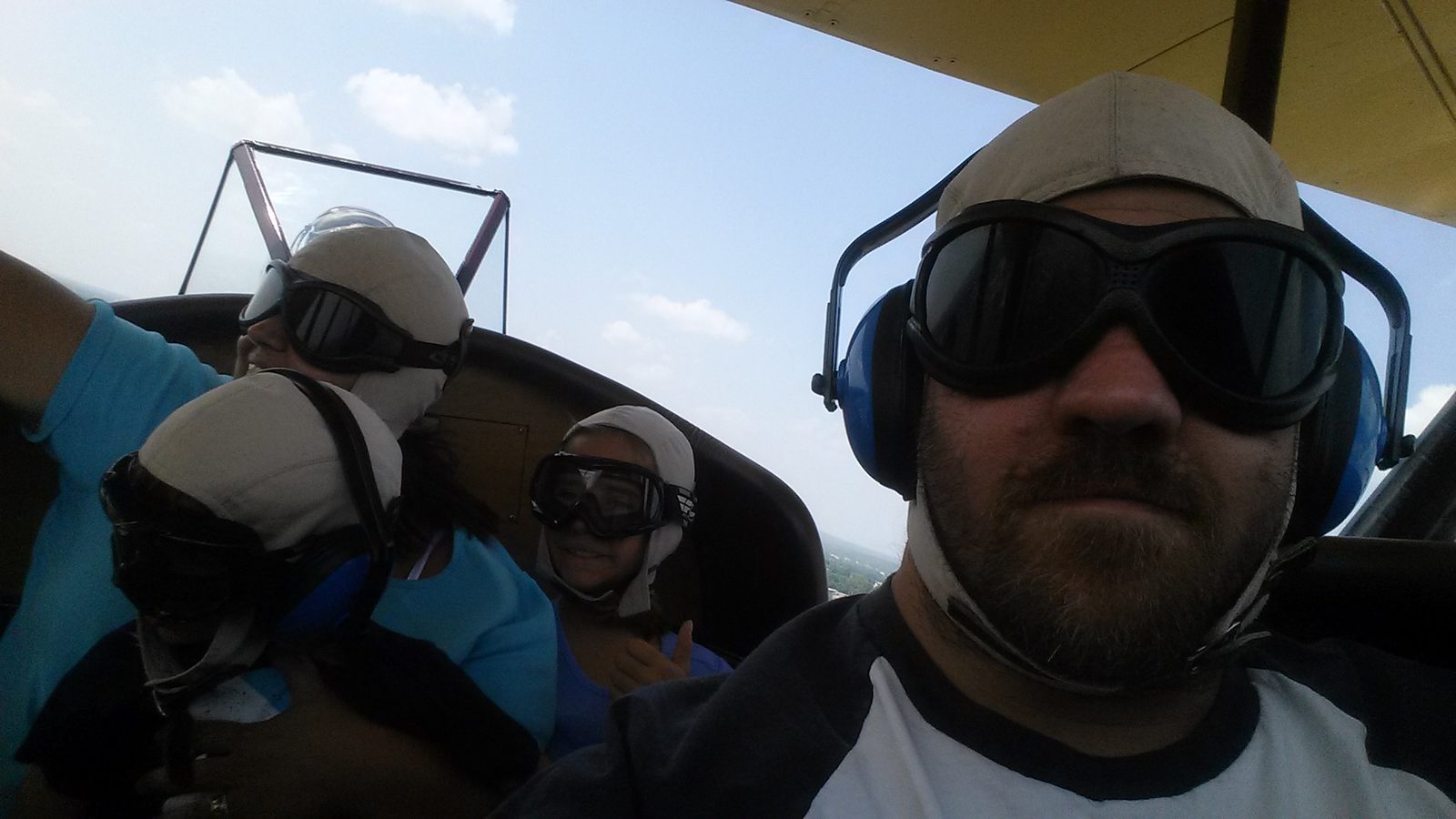 Up in the open cockpit, fields spread out below