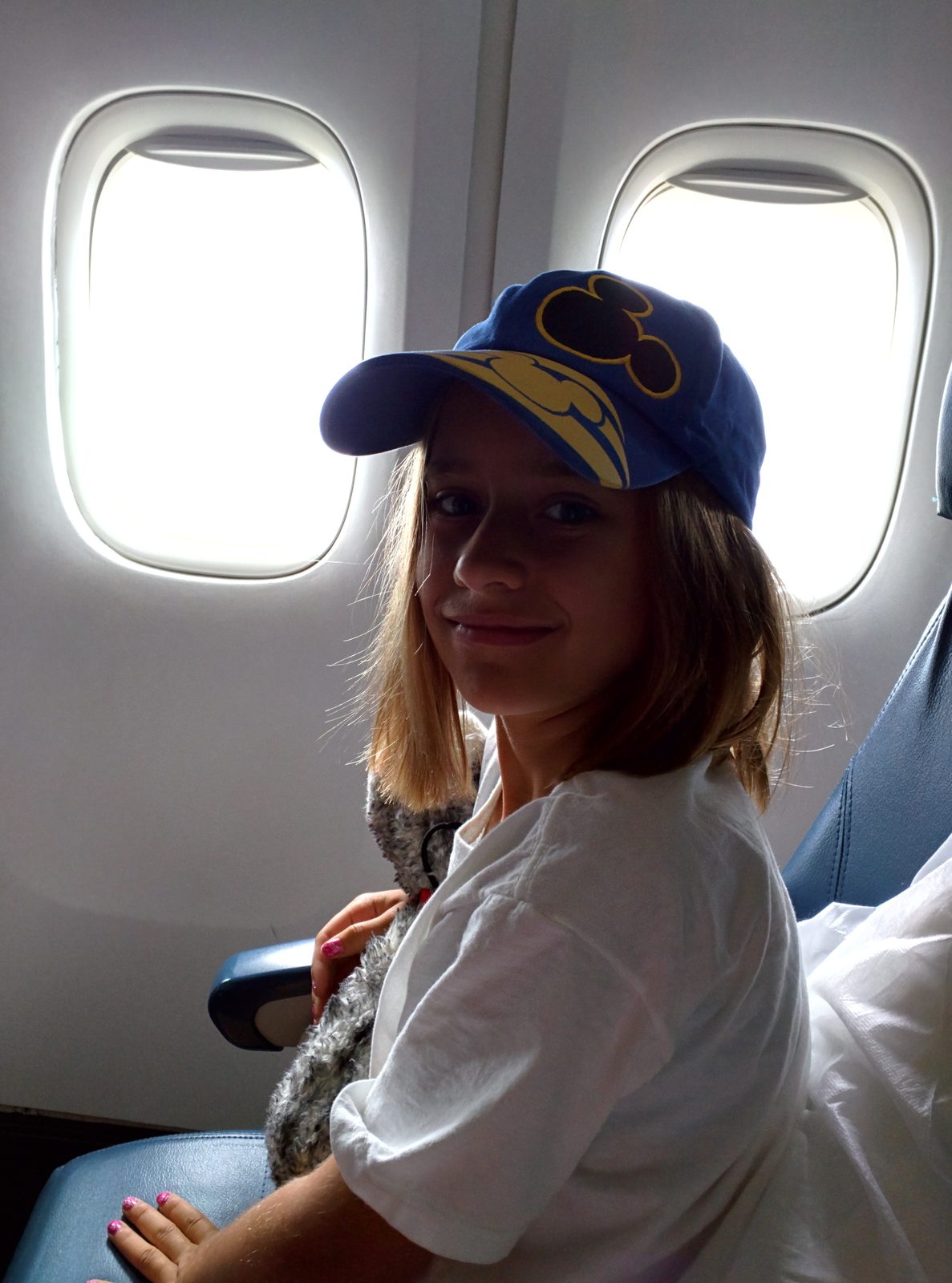 Lisa's Mickey ears on the overnight flight to Paris