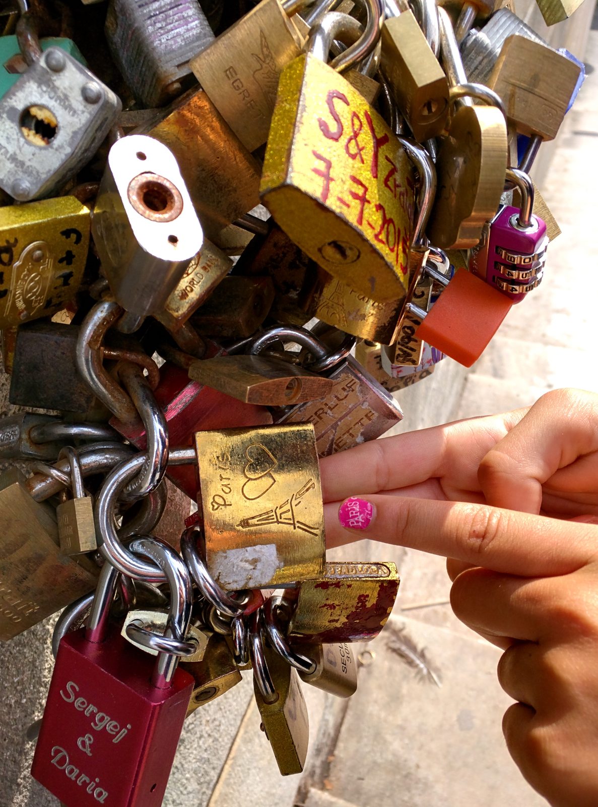 Lisa attaching a padlock to the bridge