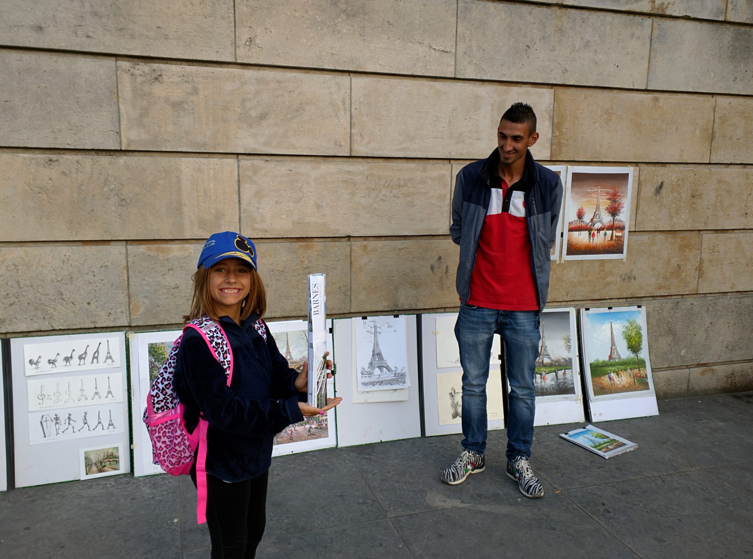 Street artists near the Eiffel Tower gifted lisa some art