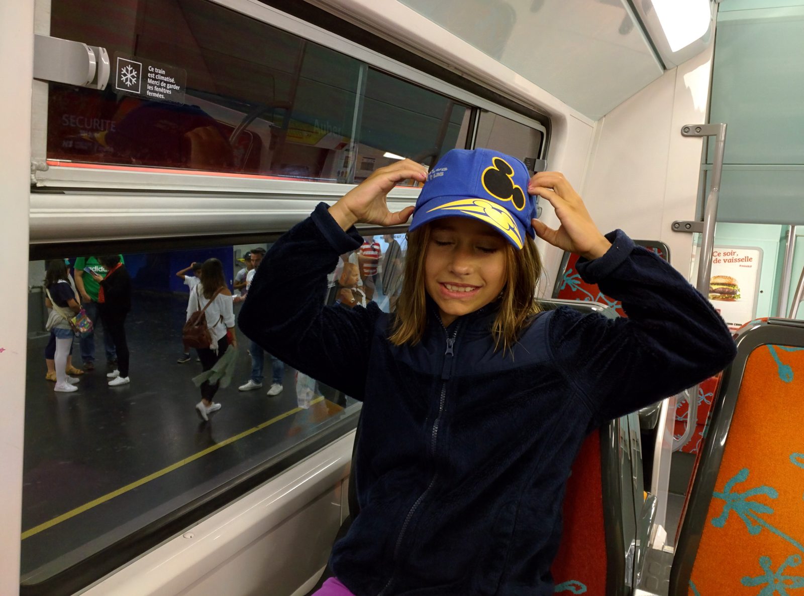 Lisa's Mickey ears on the train to Disneyland