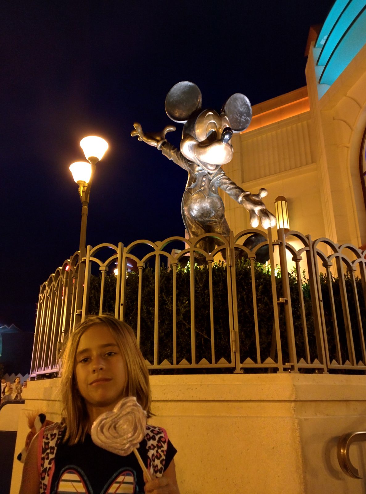 Lisa and the Mickey statue at night