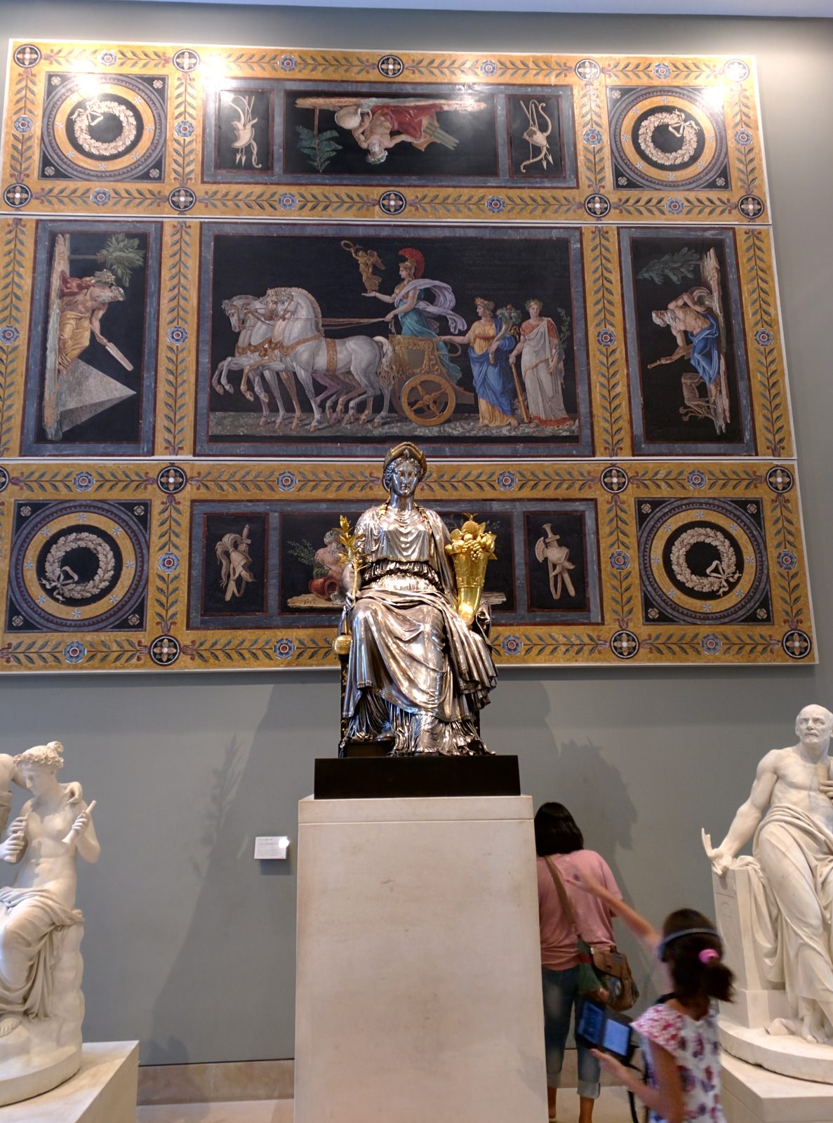 A gilded wall panel and statue in the Louvre