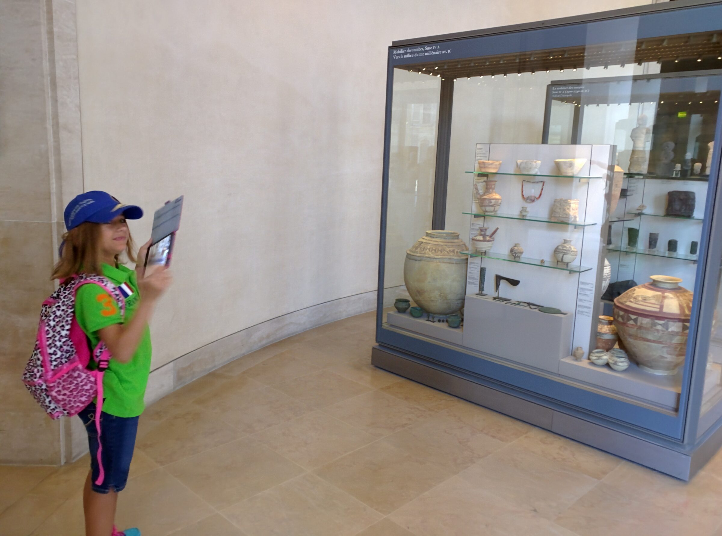 Lisa photographing artifacts at the Louvre