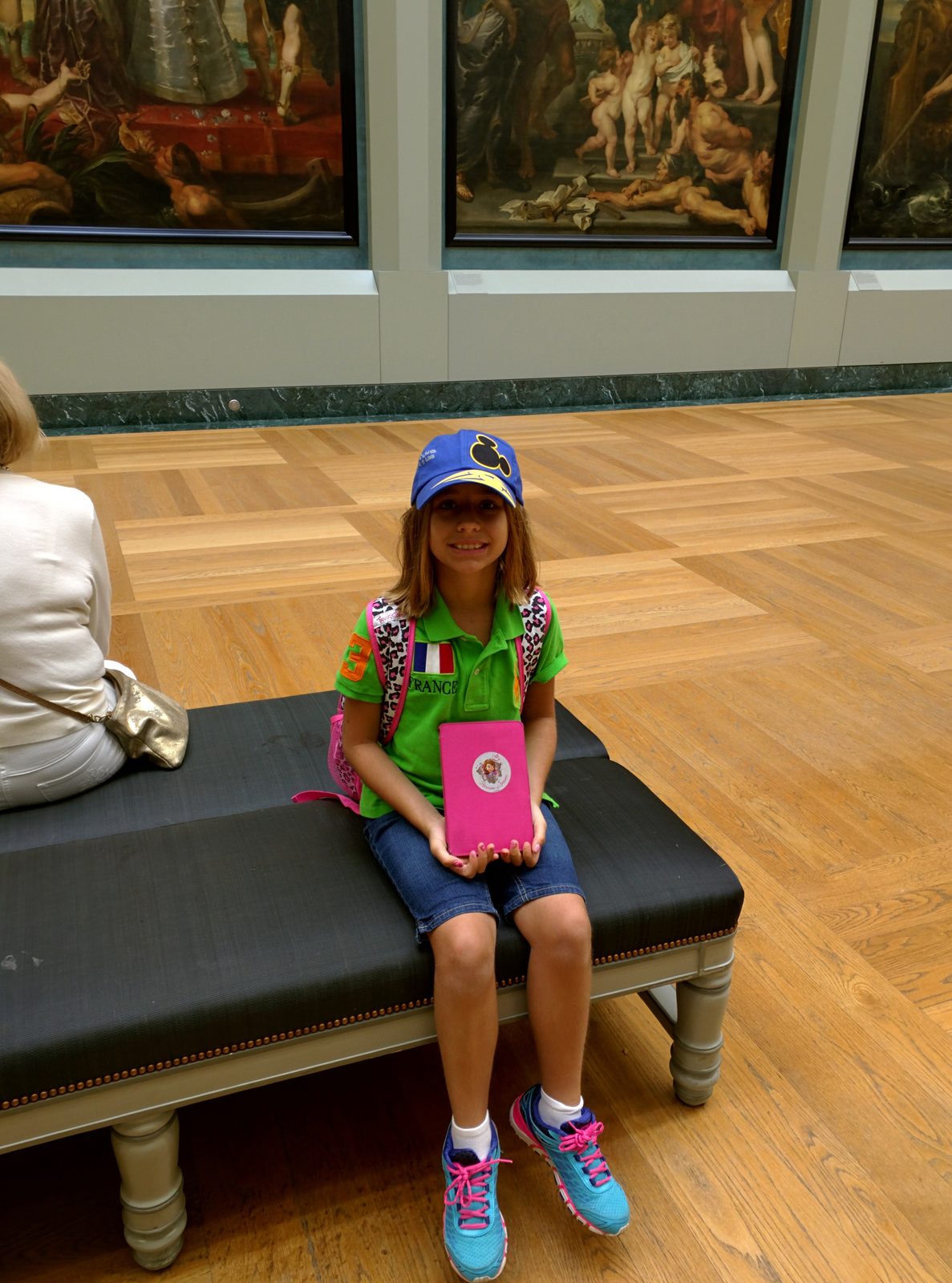 Lisa resting with her iPad in the Louvre galleries