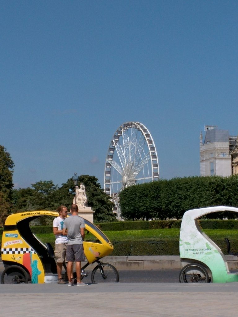 Bike taxis and the Ferris wheel from the Louvre
