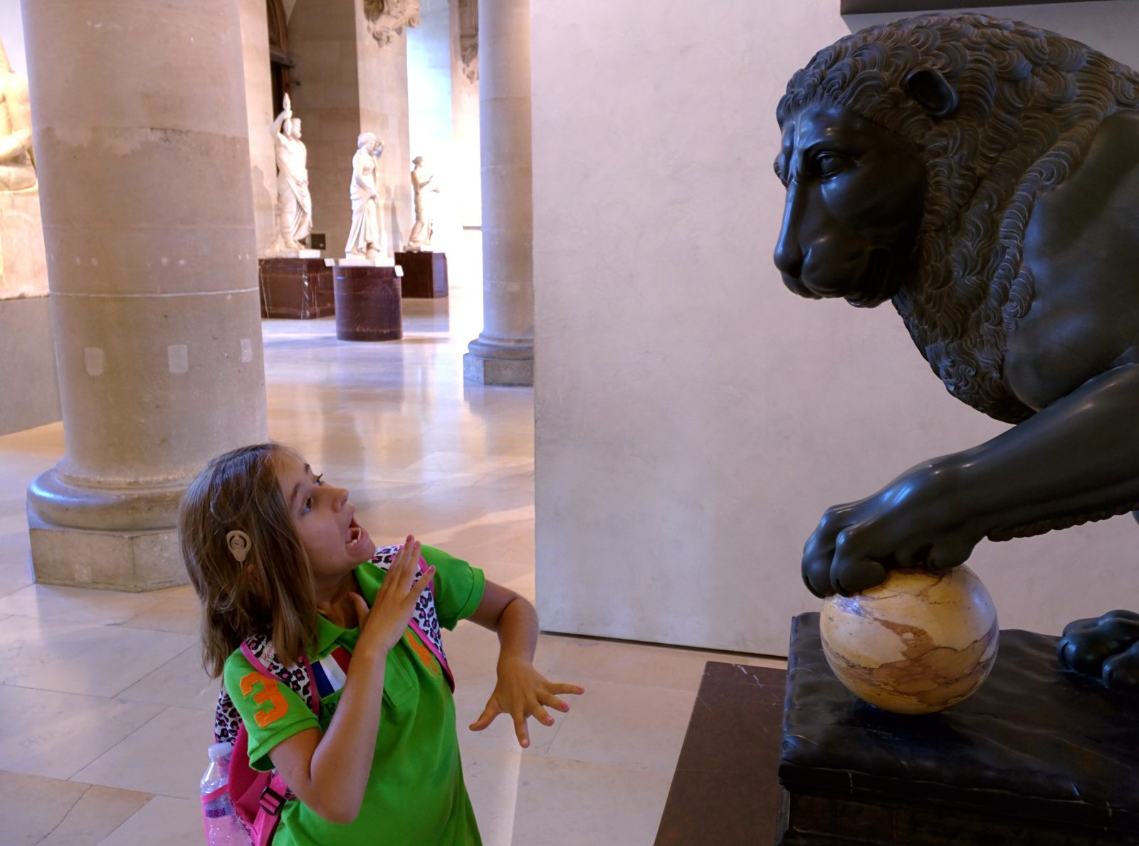 Lisa and a bronze lion at the Louvre