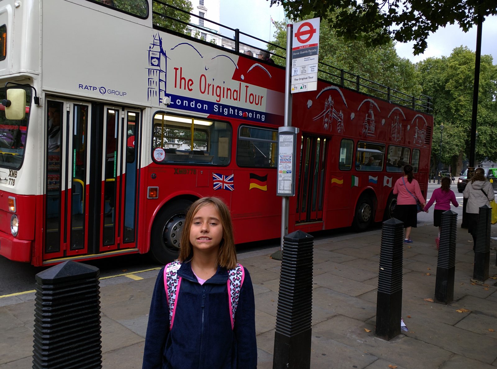 Lisa in front of a sightseeing bus
