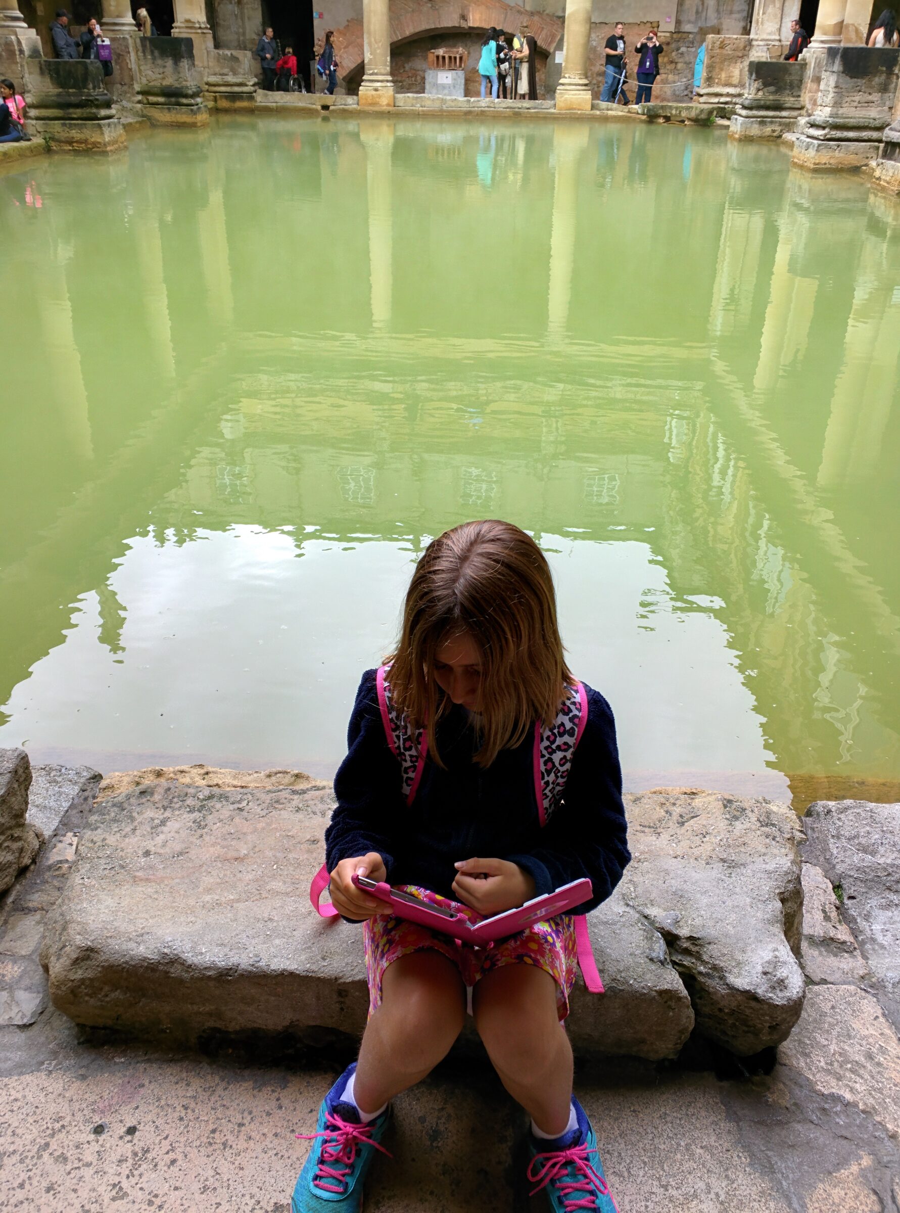 Lisa reading by the Roman Baths