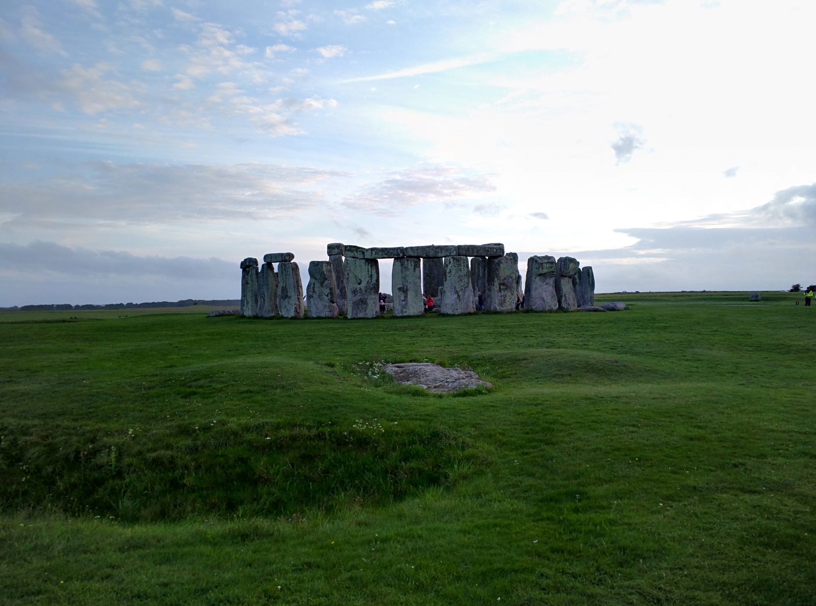Stonehenge across the grass at dusk