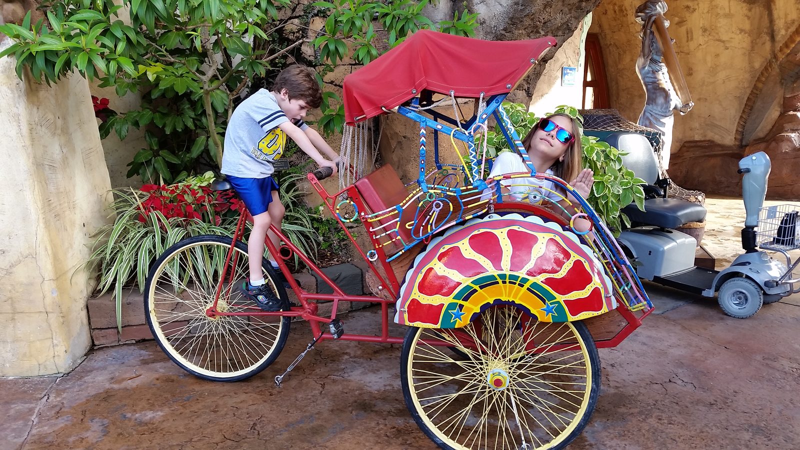 Thomas pedals the rickshaw, Lisa along for the ride