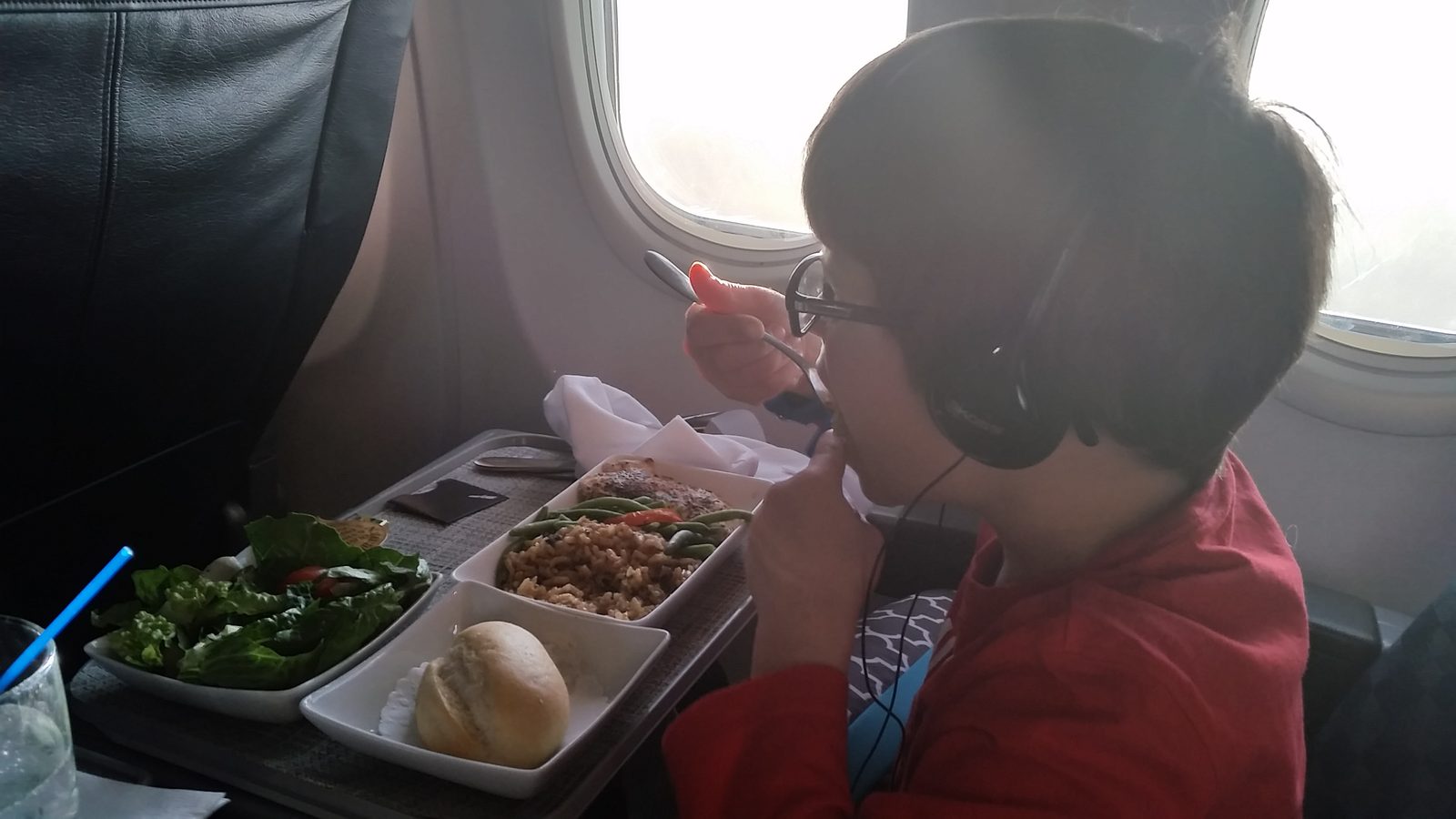 Thomas digging into his airplane dinner
