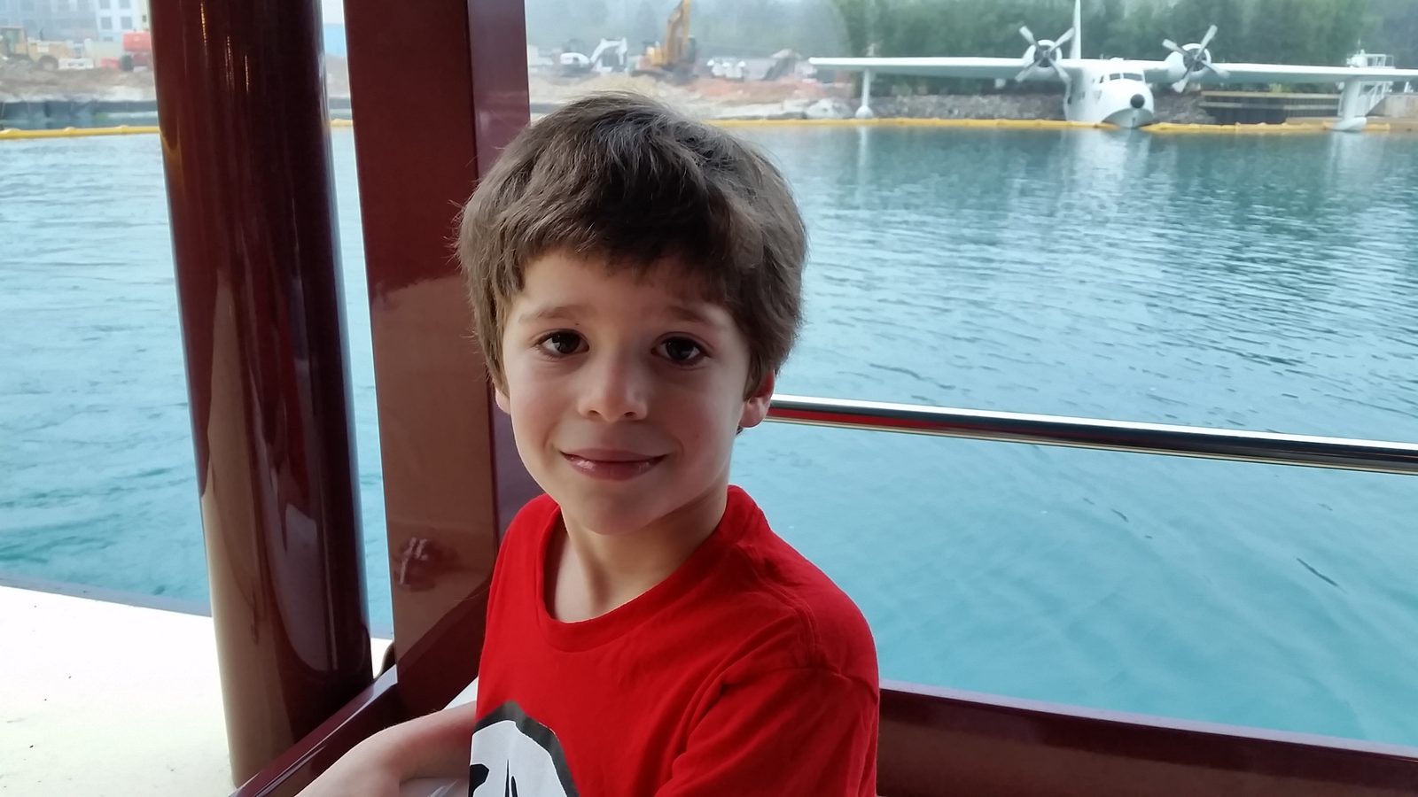 Thomas on the water taxi with a seaplane behind