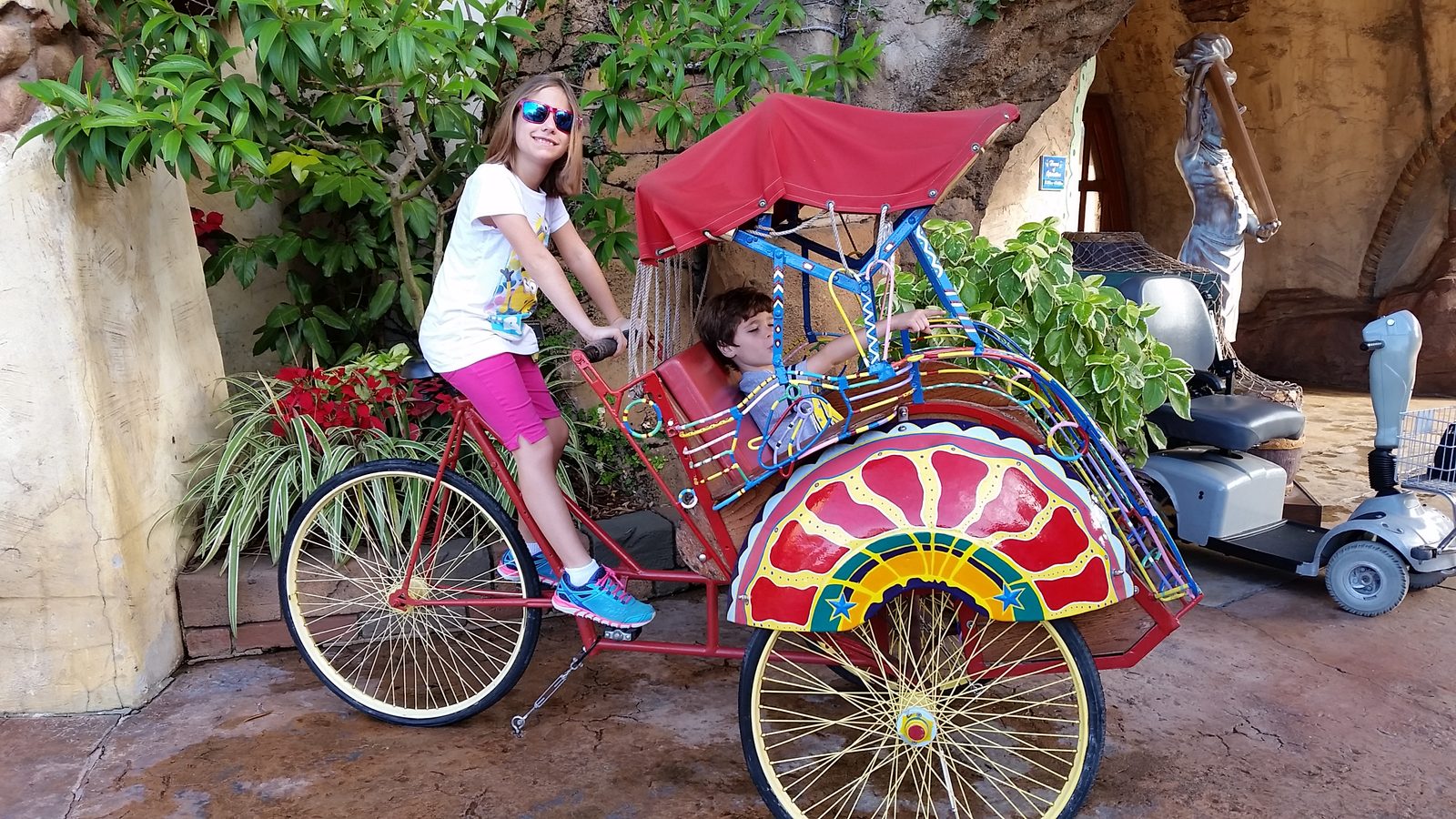Lisa pedaling Thomas in the rickshaw at Port of Entry