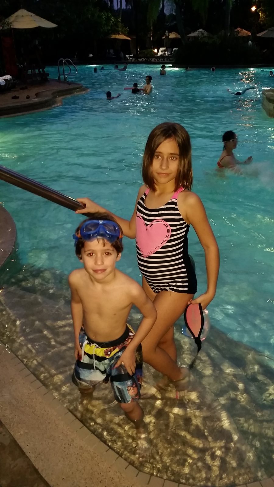 Lisa and Thomas swimming with goggles at the resort