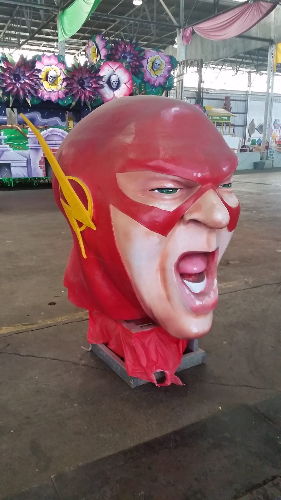 A towering red superhero float head