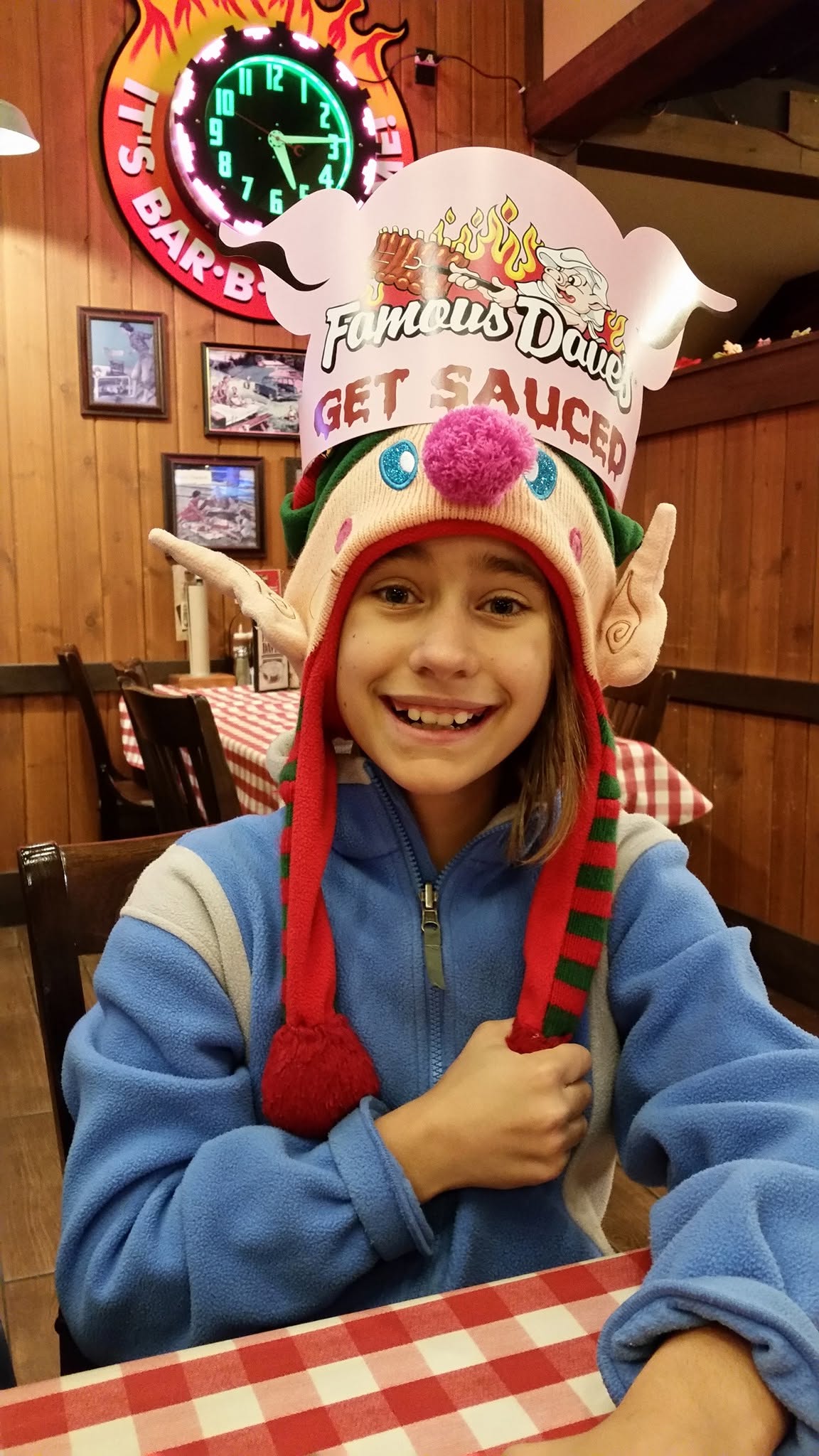 Lisa in her elf hat at Famous Dave's