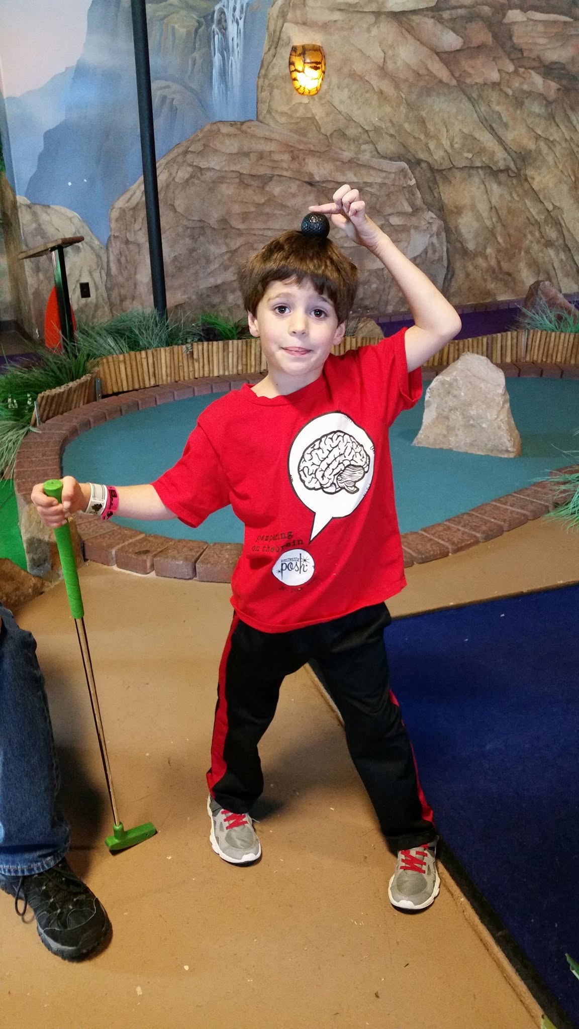 Thomas with his putter at mini golf