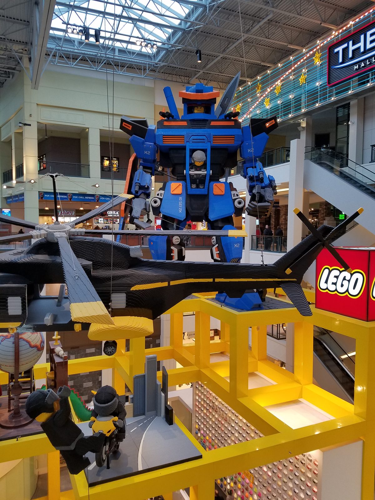 The LEGO robot and helicopter over the store
