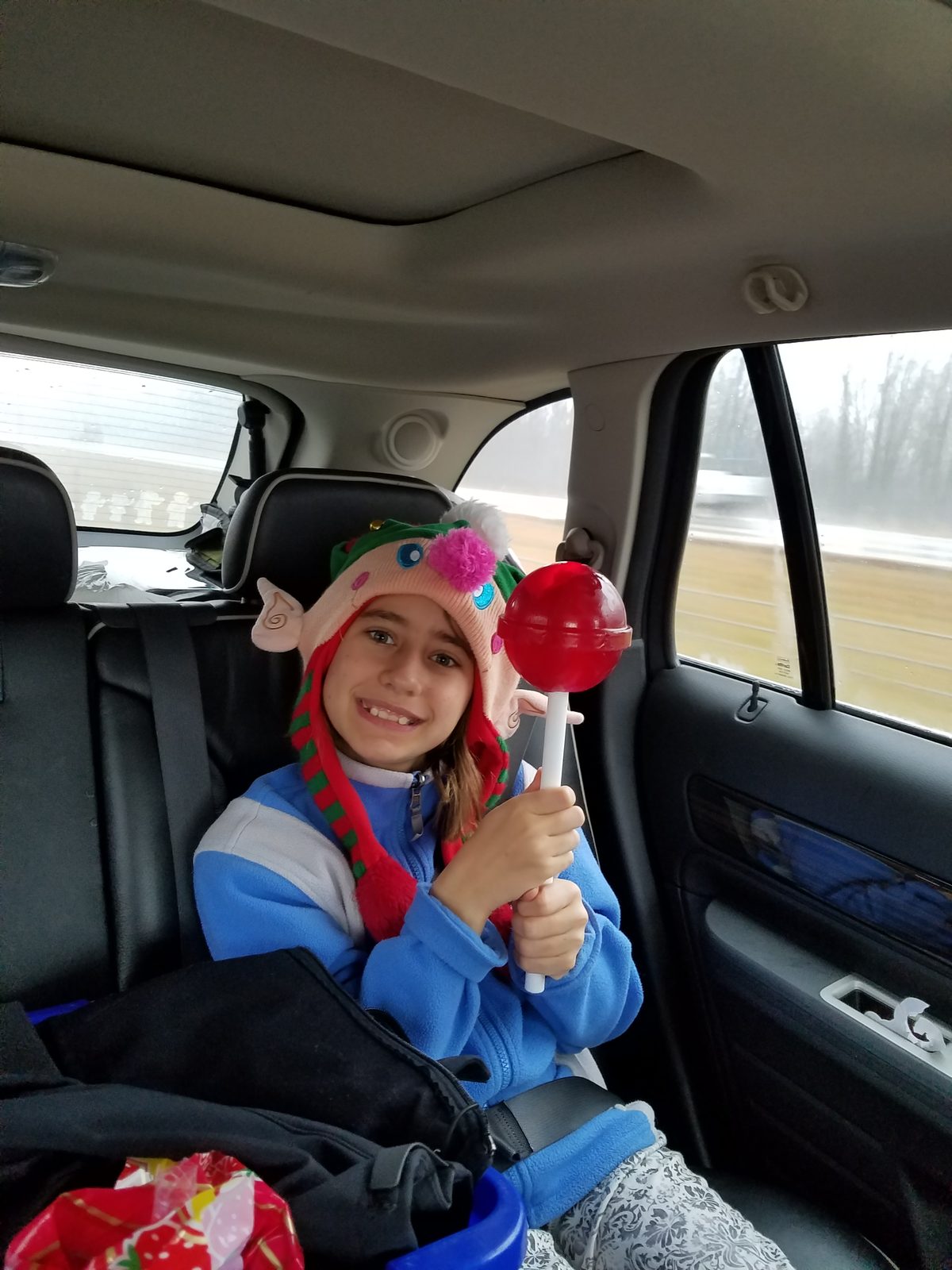Lisa's elf hat and lollipop on the road to Grandma's
