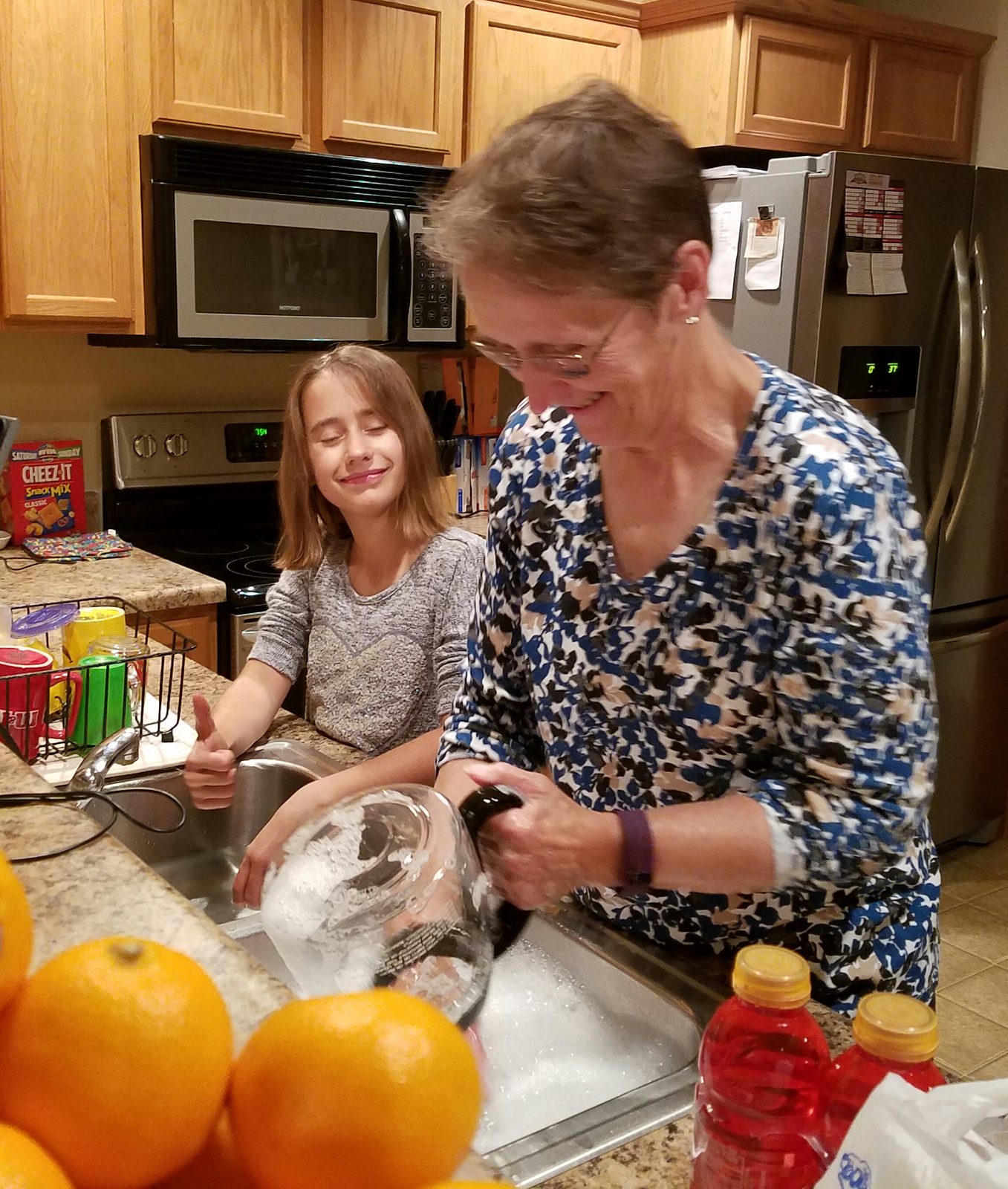 Lisa and Grandma mixing something in the kitchen