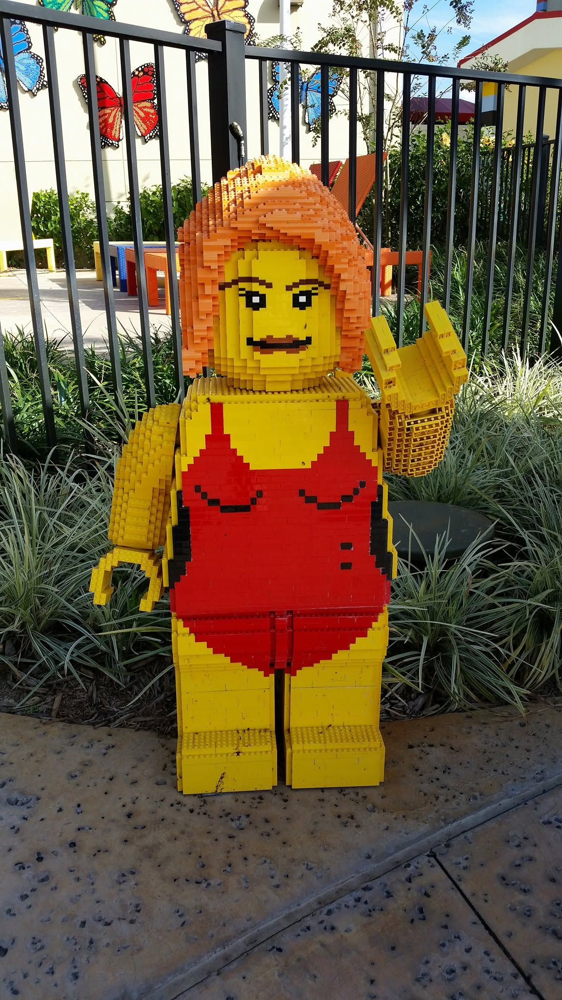 A LEGO woman in a red swimsuit by the hotel pool