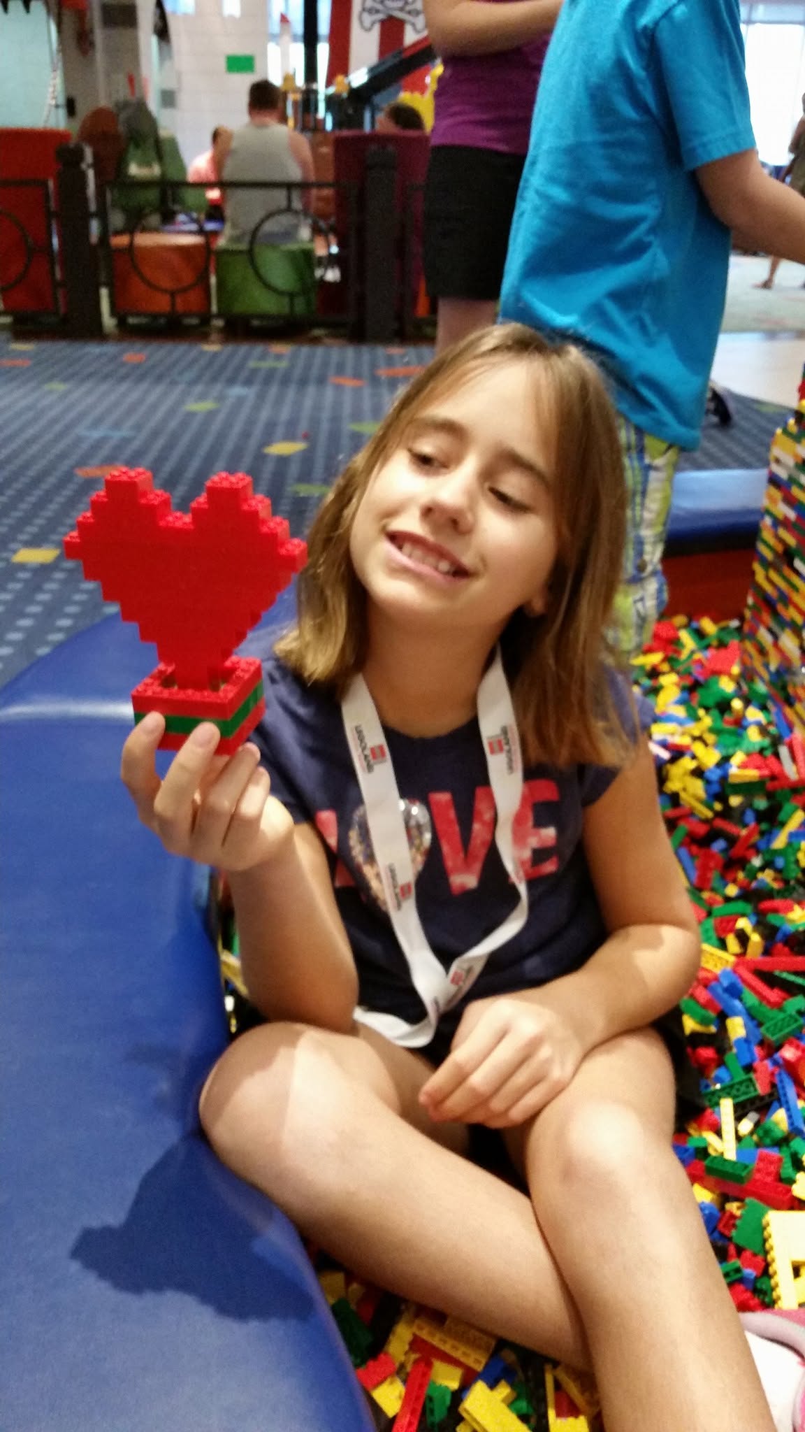 Lisa with her LEGO heart by the lobby brick pit