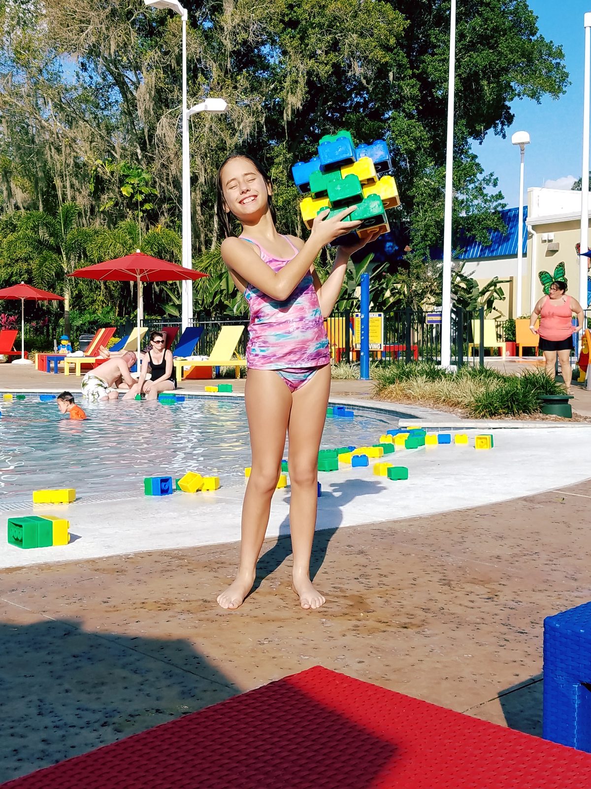 Lisa collecting foam Duplo blocks at the splash pad