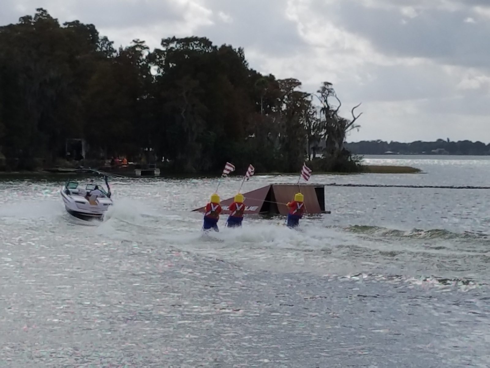 Skiers towing a pyramid at the show
