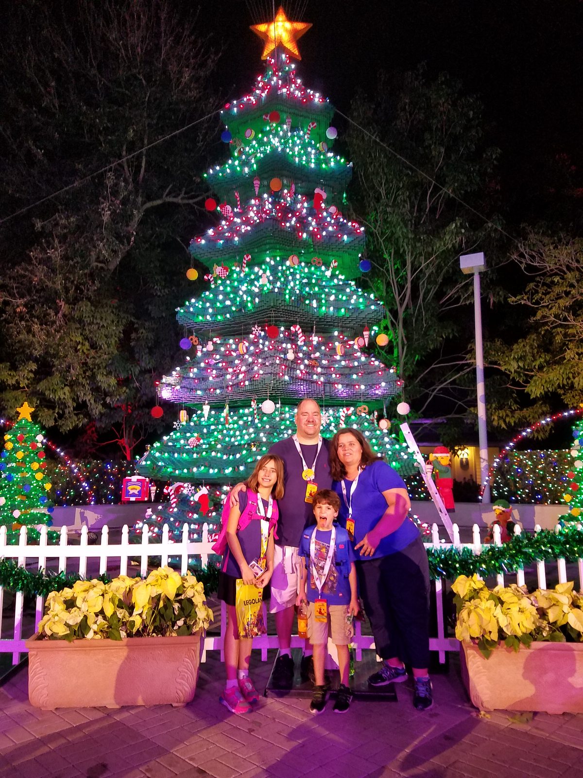 All four of us at the lit Christmas tree