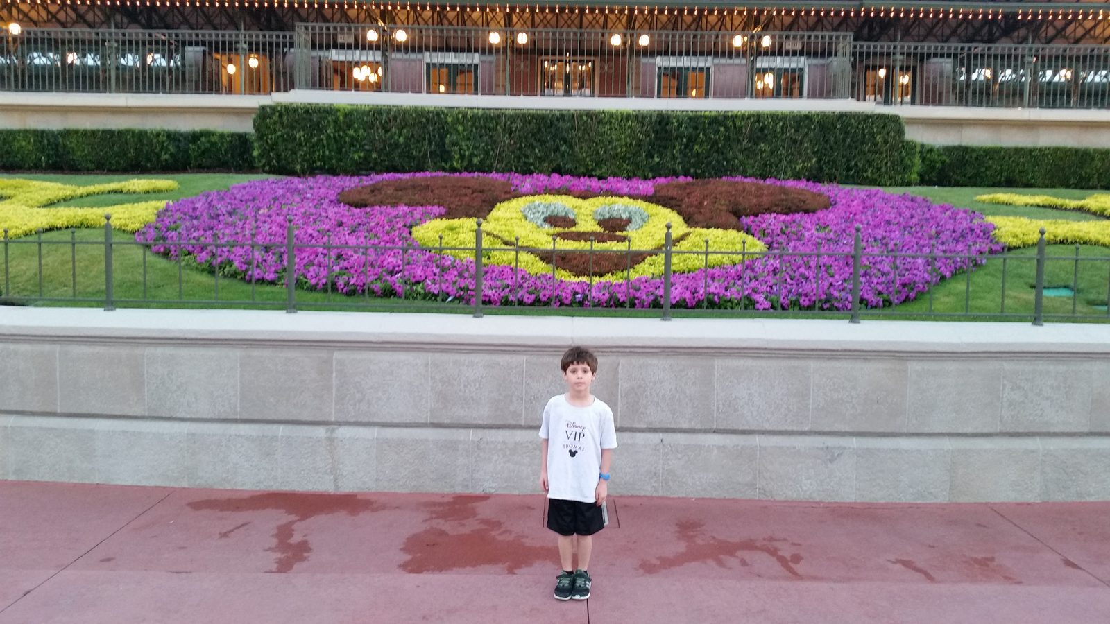 Thomas in front of the Mickey flower bed at the Magic Kingdom