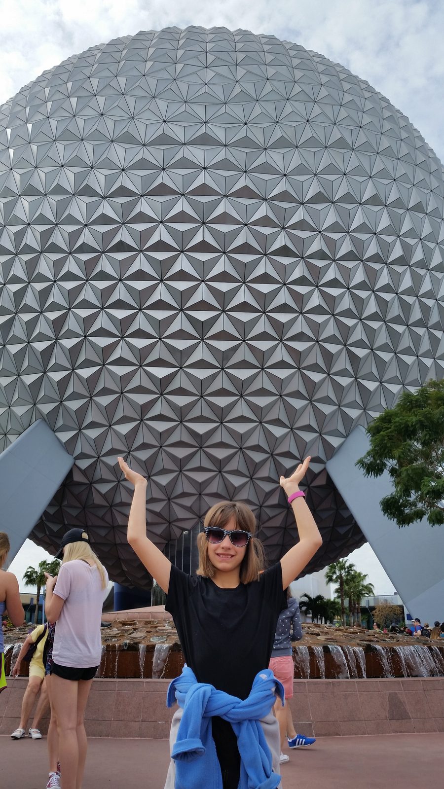 Lisa holding up Spaceship Earth
