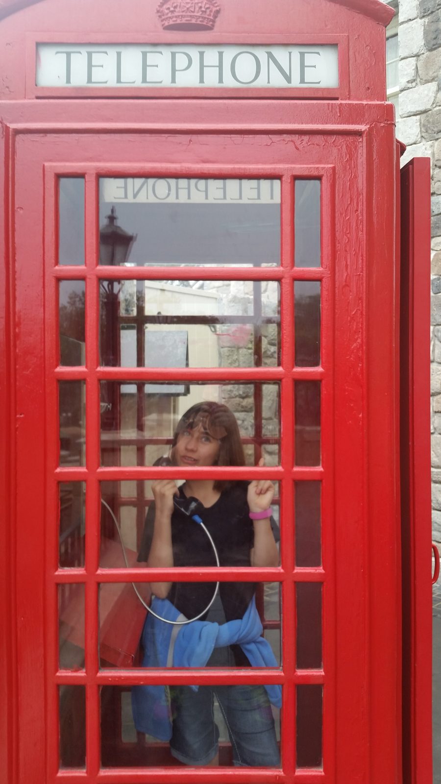 Lisa in a red phone booth