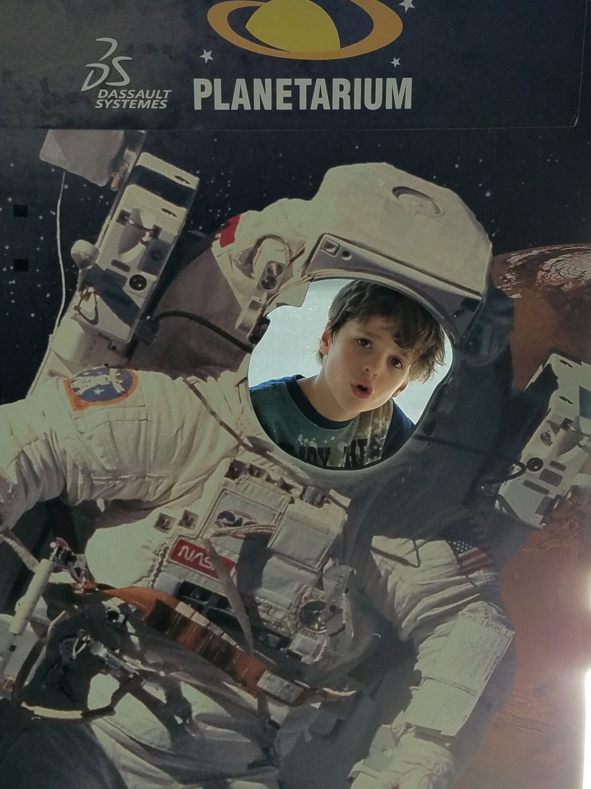 Thomas tries on a spacesuit outside the planetarium