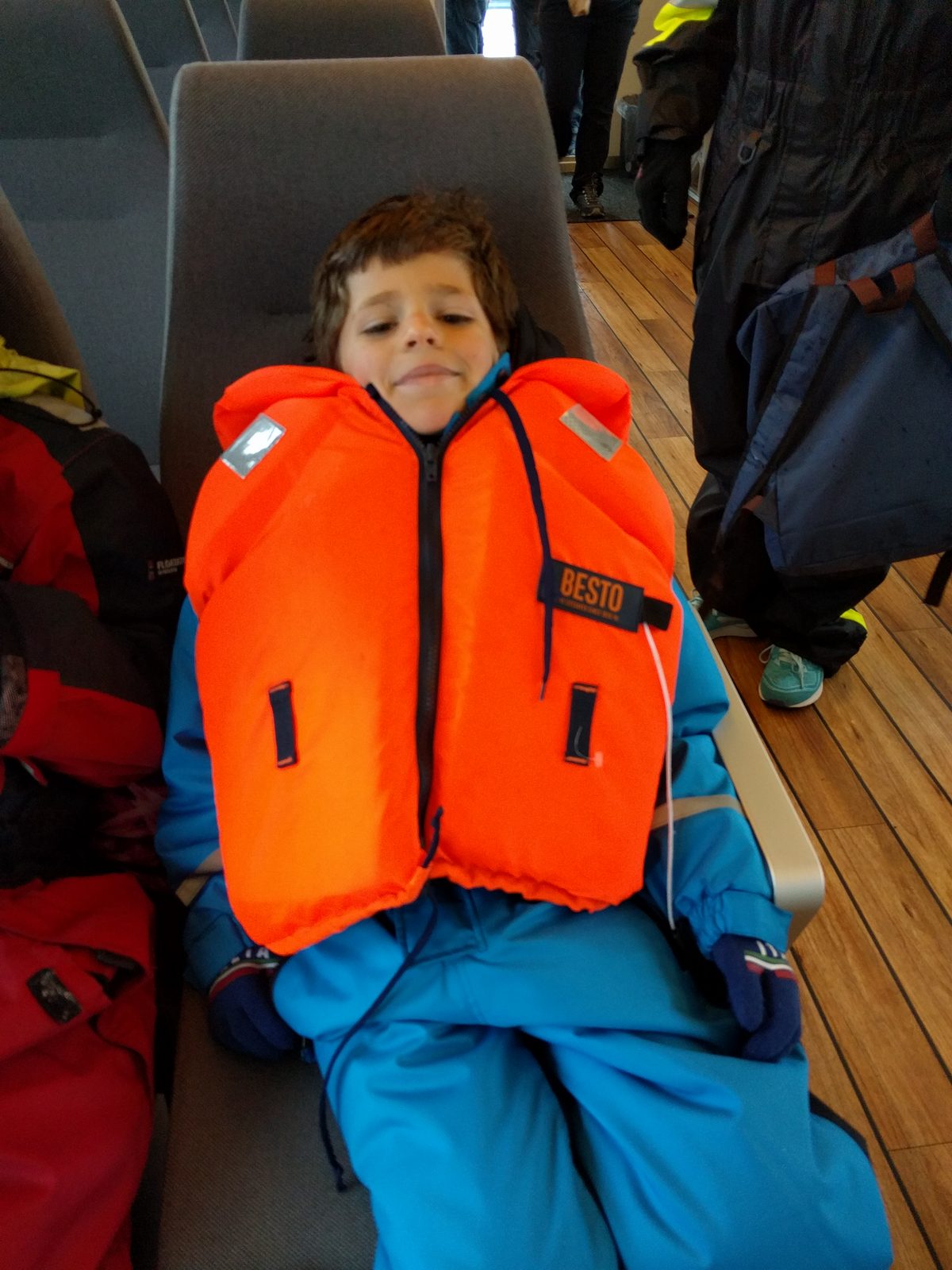 Thomas in his life vest on the whale watching boat