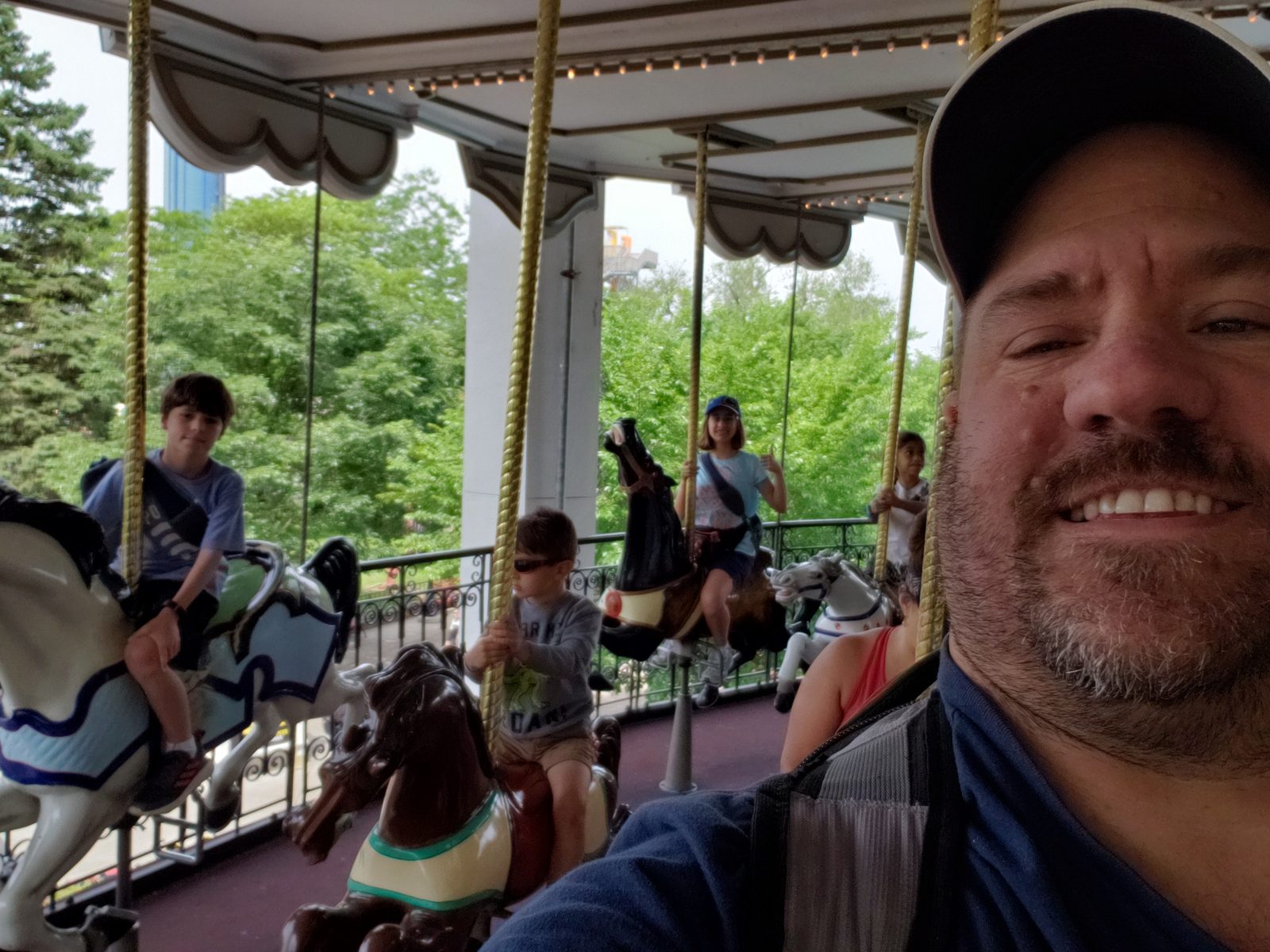 On the carousel, Lisa and Thomas riding behind me