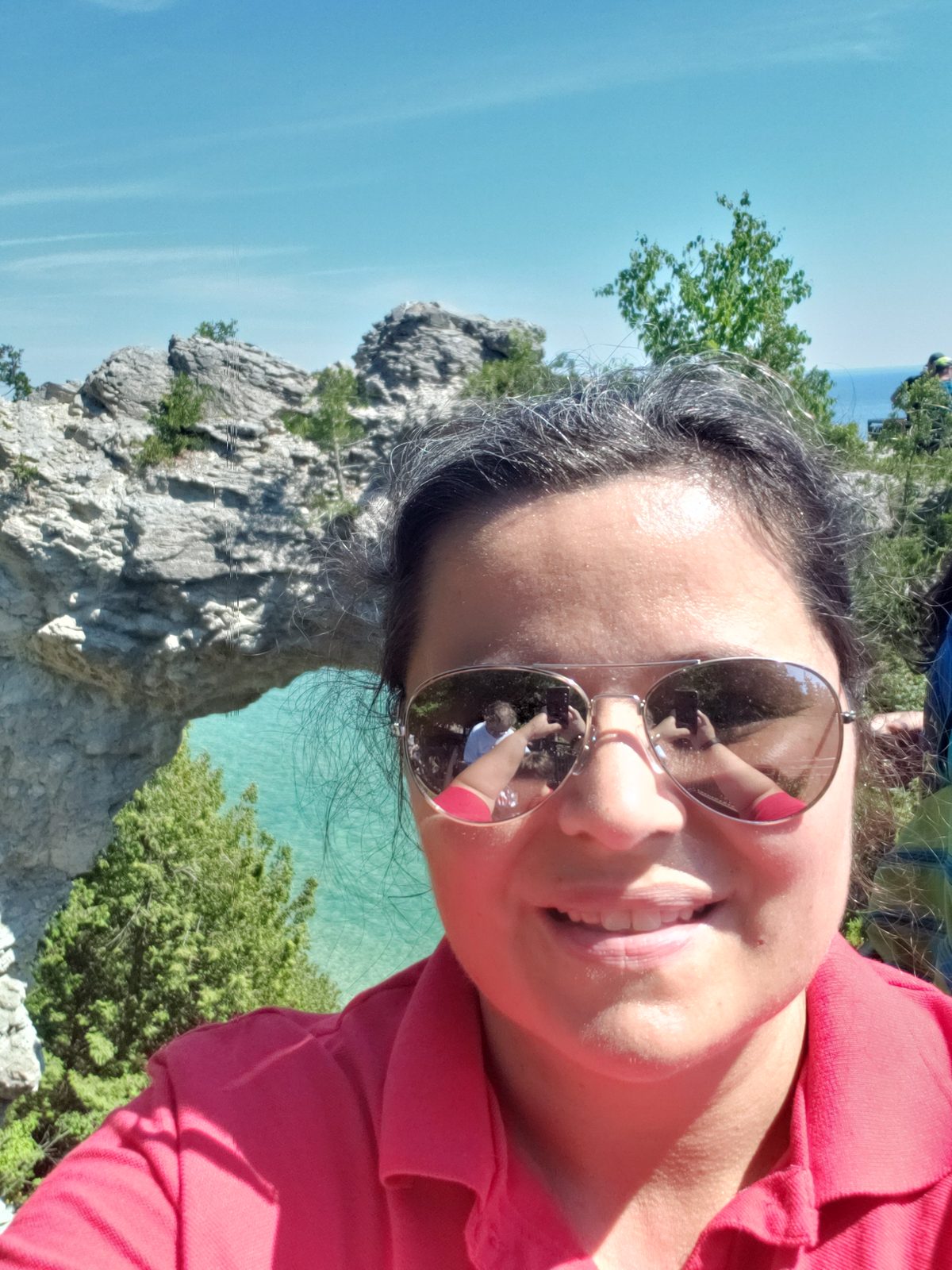 Kathy's selfie with Arch Rock behind her