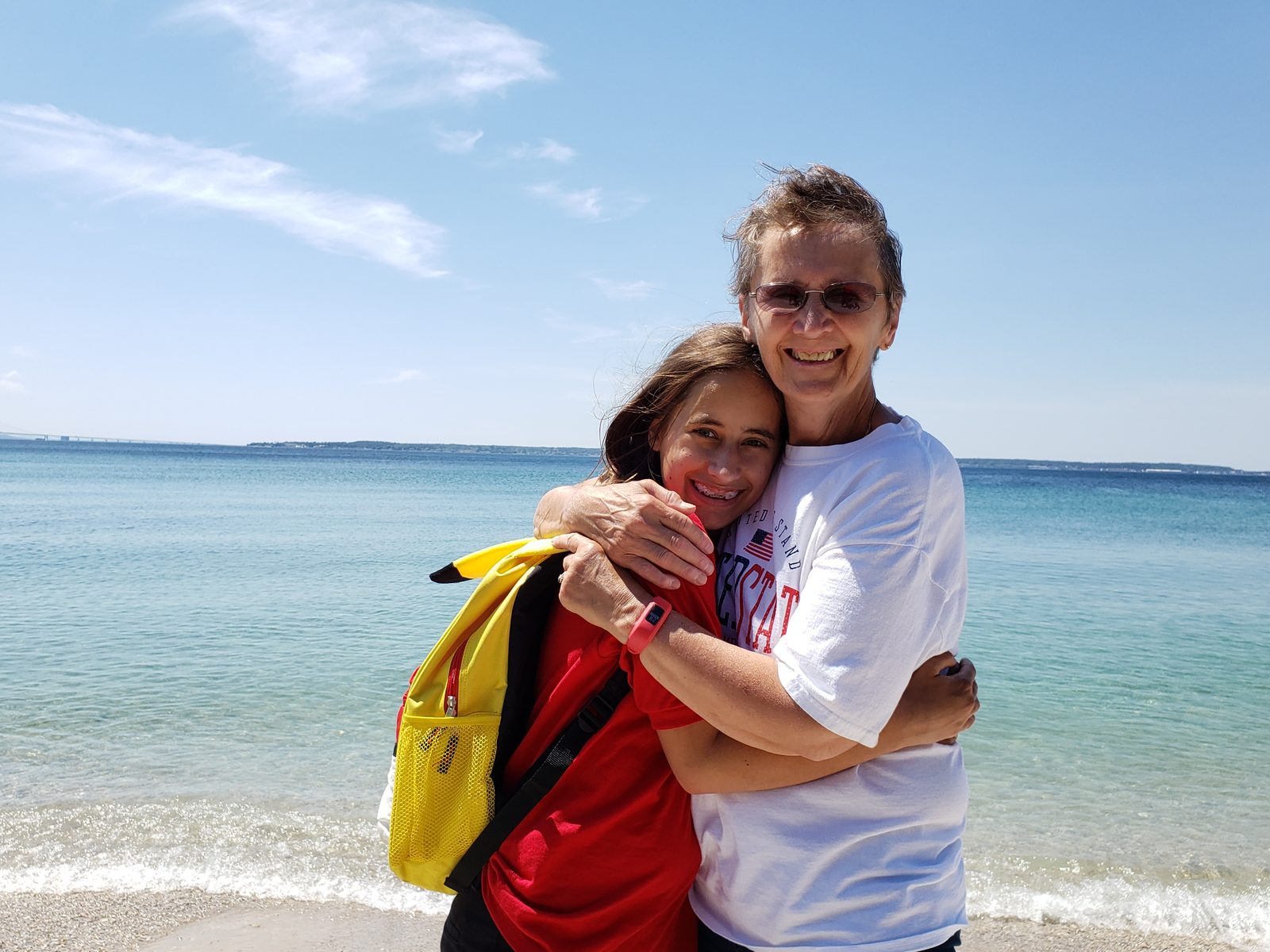 Lisa and Grandma, a hug on the rocky shore