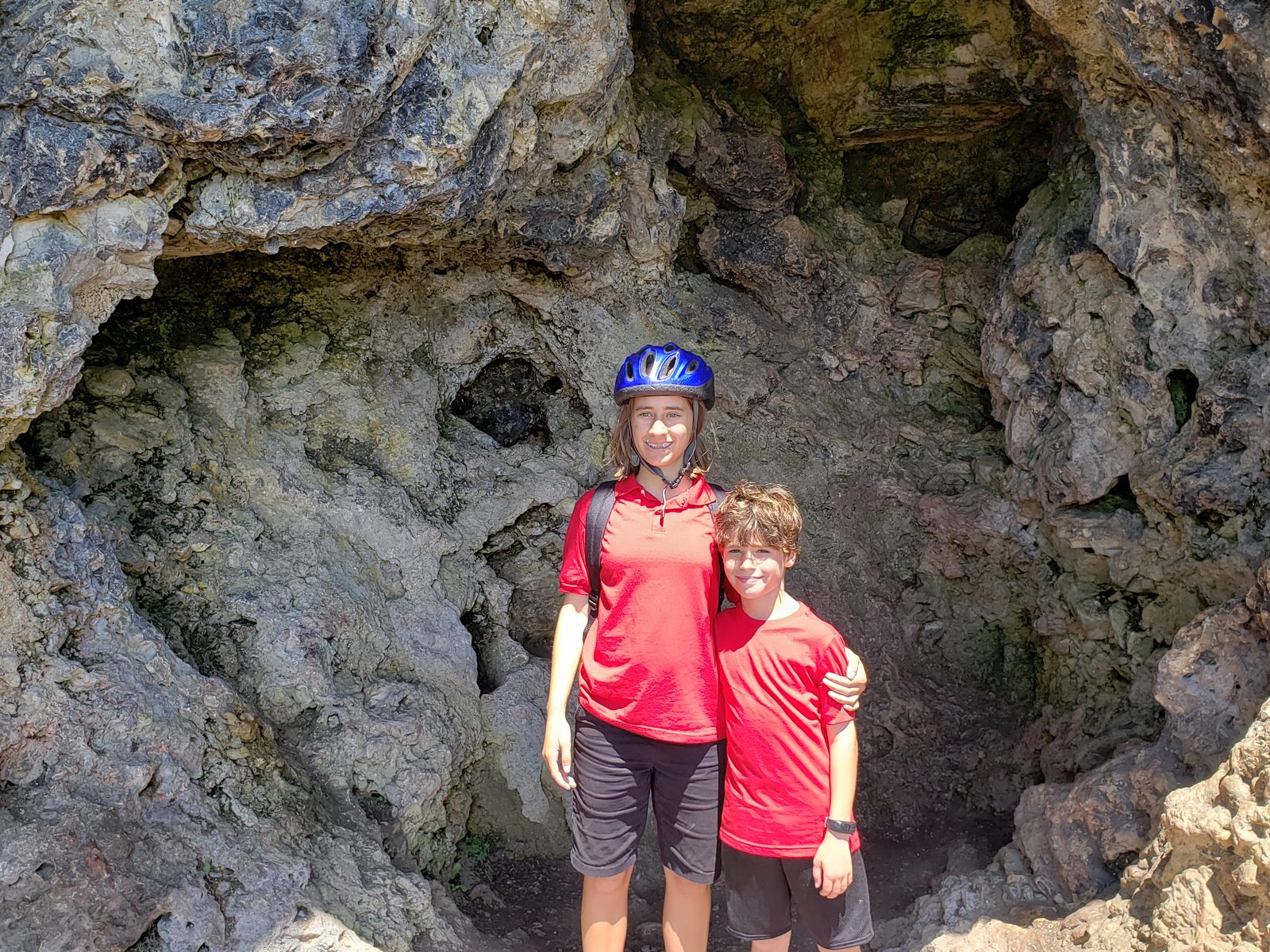 The kids at a rock cave on the bike ride