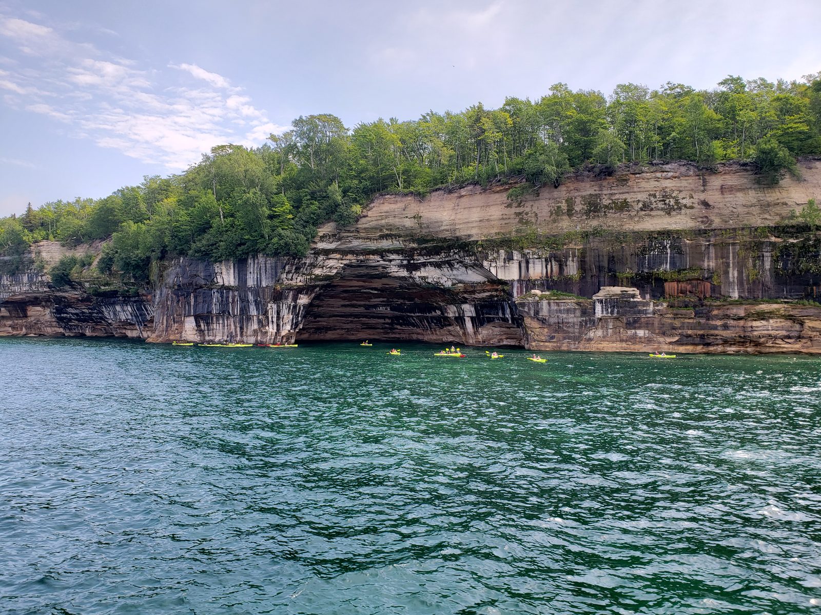 Kayakers below the Pictured Rocks cliffs