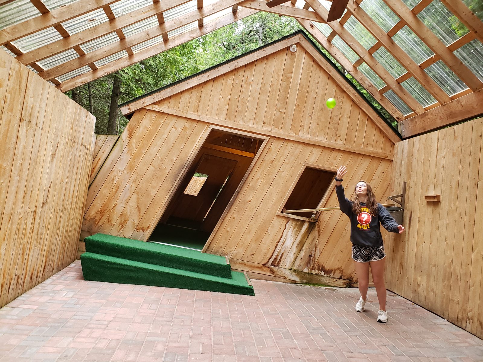 Lisa tipping over inside the Mystery Spot
