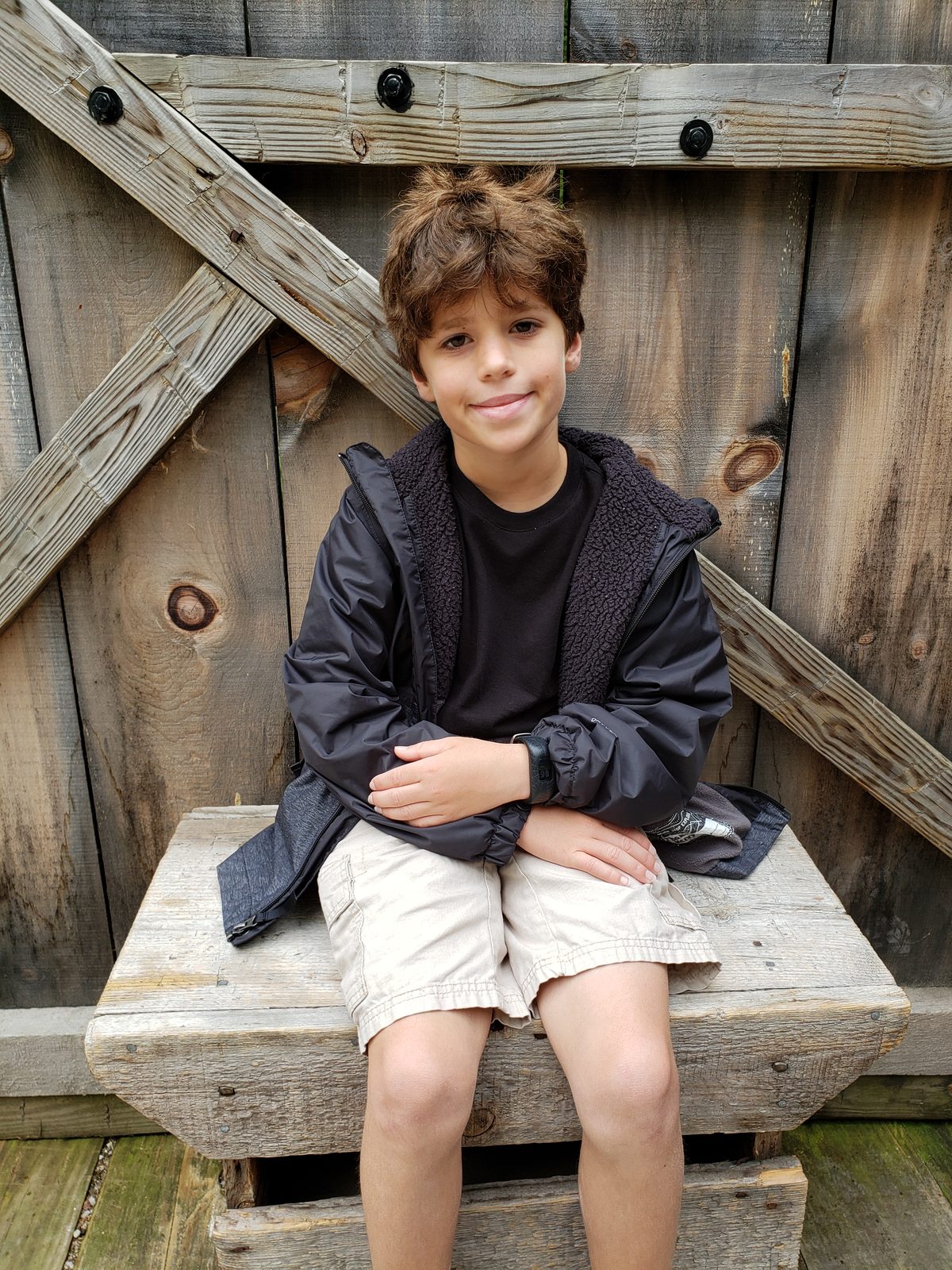 Thomas on a wooden bench at Mill Creek