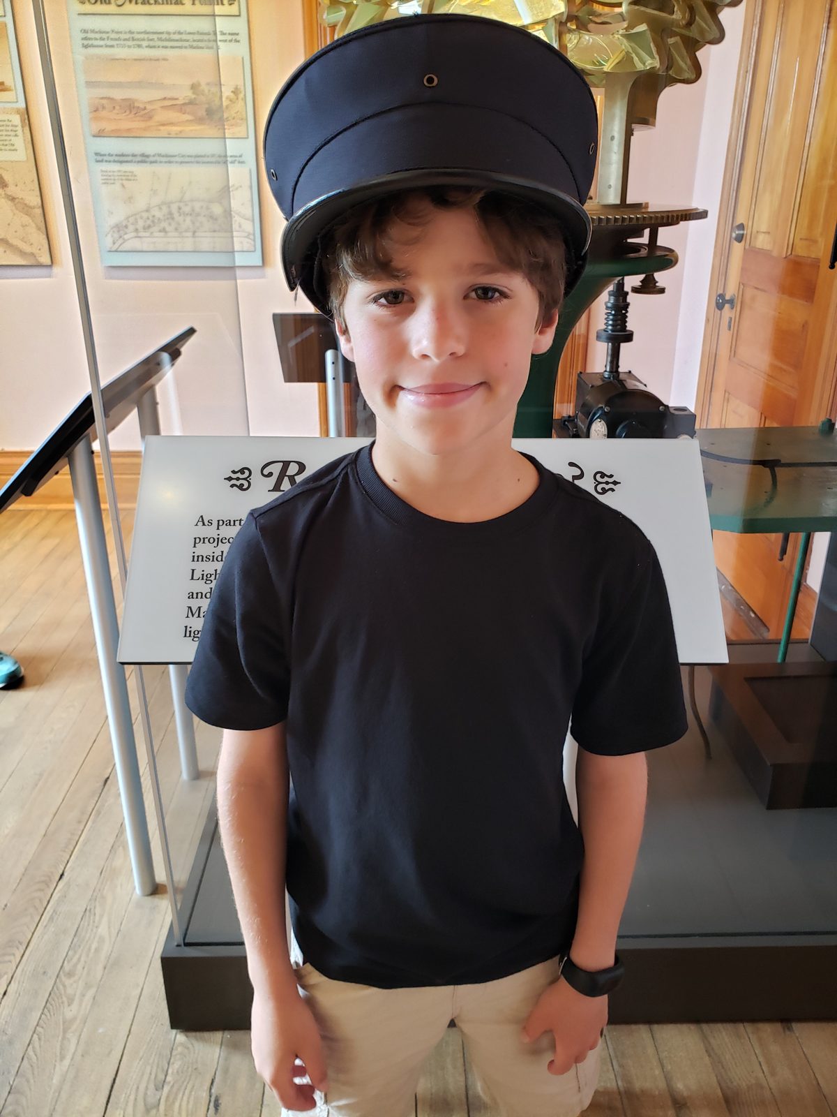 Thomas trying on a hat at the lighthouse museum