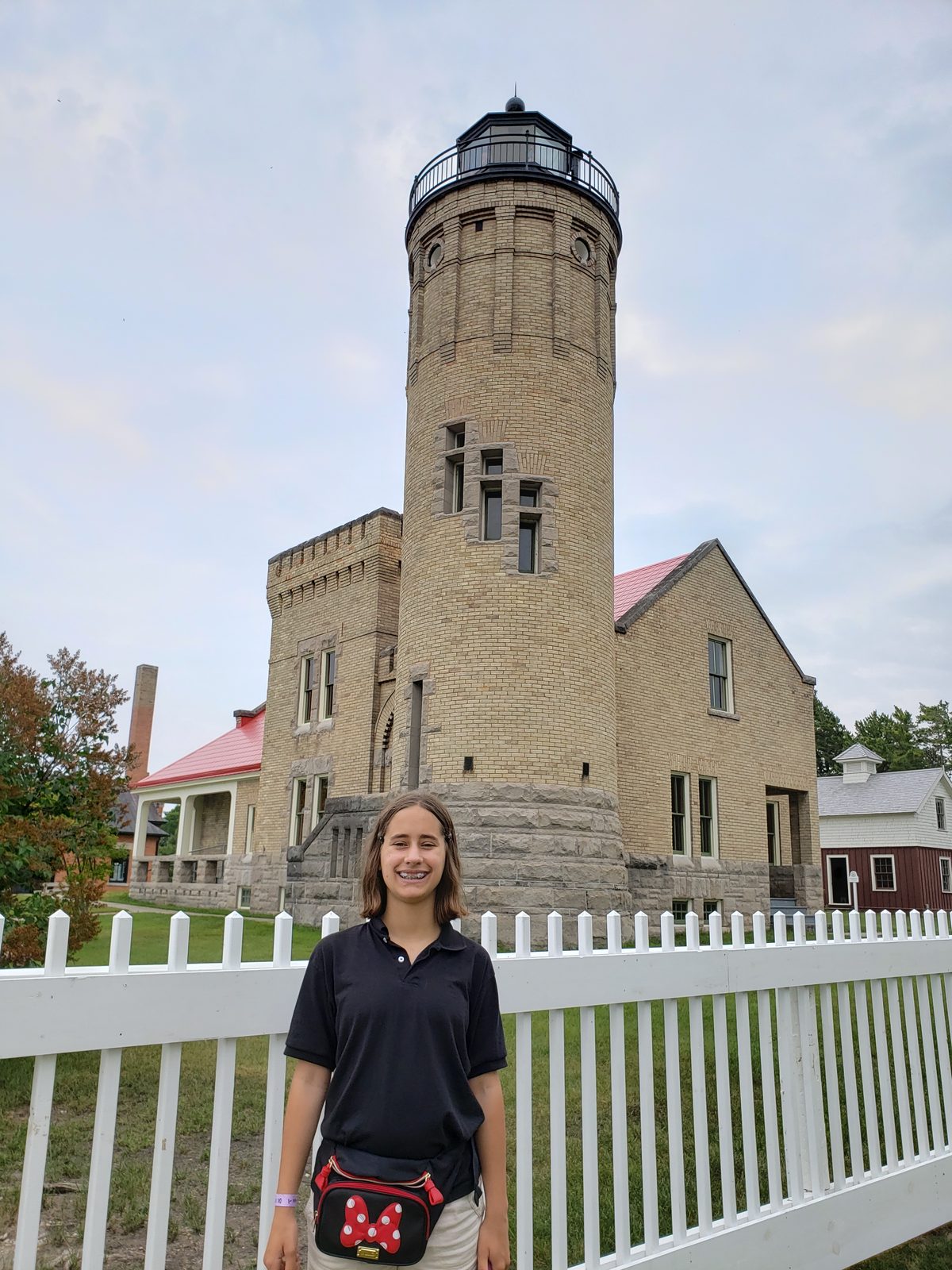 Lisa in front of the Old Mackinac Point Lighthouse tower